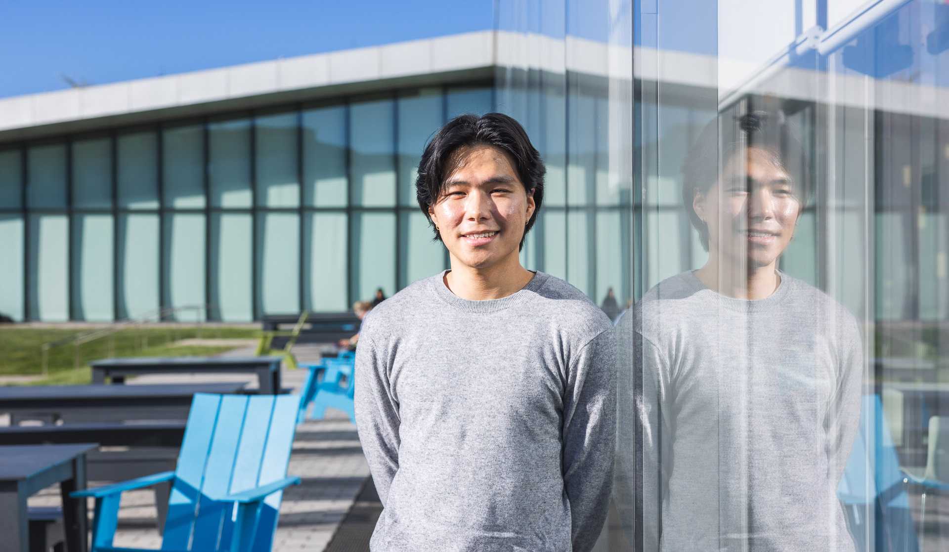 InKyoo Whang standing in front of a building